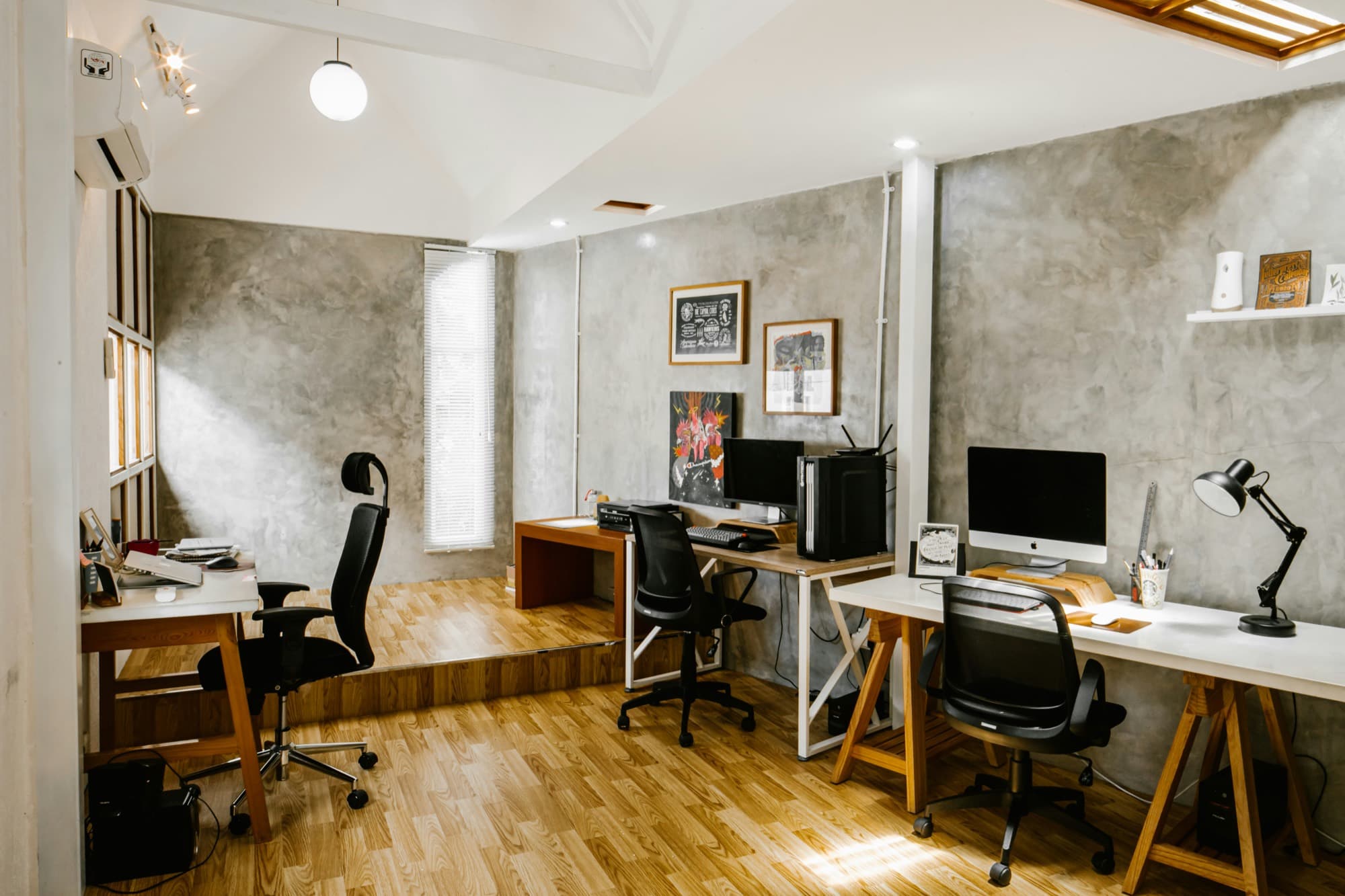 A bright studio workspace with desks and monitors